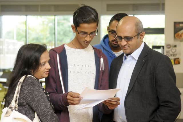 GCSE results at Fulwood Academy.  Nilay Patel opens his results with his family.