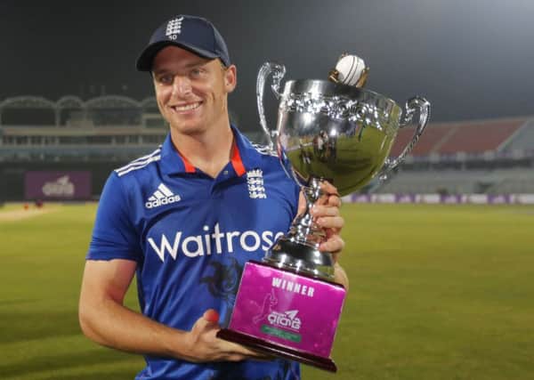 Jos Buttler with the winners' trophy for their series against Bangladesh after the third one-day international in Chittagong