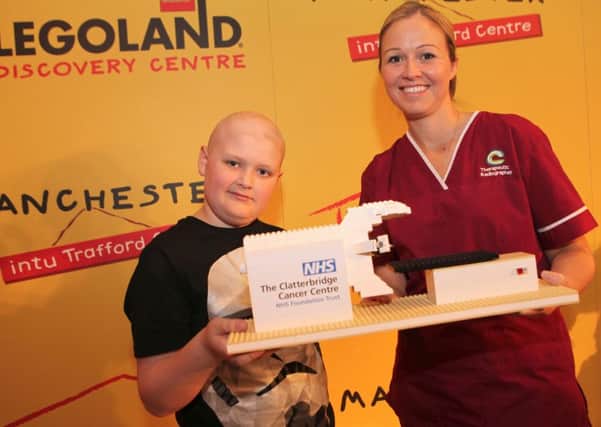 LEGOLAND Discovery Centre Manchester has built a LEGO model radiography machine which will be donated to help staff explain treatment to children at The Clatterbridge Cancer Centre.  

Pictured Sarah Stead, Paediatric Specialist Radiographer at The Clatterbridge Cancer Centre, Reece Holt, a young patient who was treated with radiotherapy for a brain tumour at The Clatterbridge Cancer Centre.