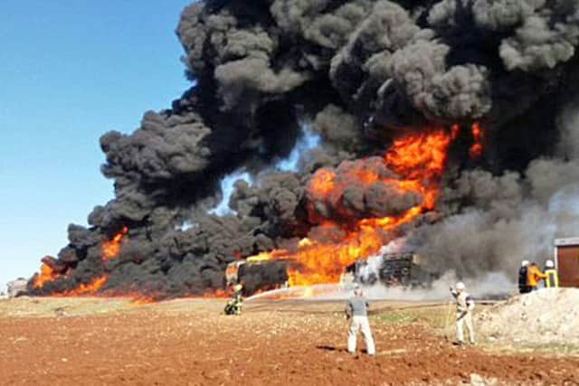 An old Lancashire fire engine helped put out this blaze caused by Russian bombers before another was caught up in bombing in Haritan