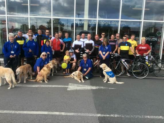 Staff from Sainsbury's Bamber Bridge with  Chorley Guide Dogs branch volunteers after completing a 275mile charity cycle