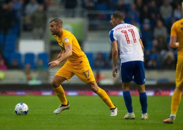 Preston North End's Tommy Spurr holds off the challenge of Brighton and Hove Albion's Anthony Knockaert.
