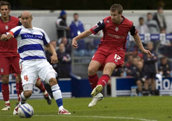 Paul Parry strikes at goal during the match against QPR