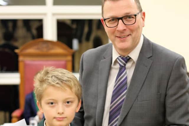 Josh Carter, 11, presented with the Carr trophy for Garstang Youth Citizen of the year by Damian Carr Pictures: Lynn Harter