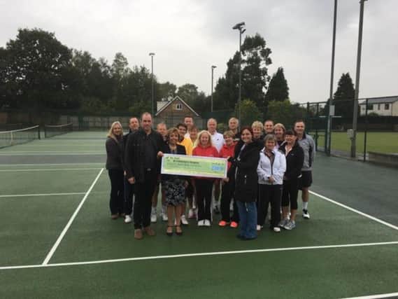 Michael Bailey and Anne Carter present the 800 cheque to Emma Jacovelli, surrounded by the 2016 tennis tournament finalists