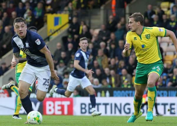 Jordan Hugill tries to get around Norwich City's Ryan Bennett