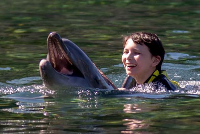 Esther Castle, 14, from Lancaster, enjoys a swim with a dolphin during the Dreamflight visit to Discovery Cove in Orlando, Florida. PRESS ASSOCIATION Photo. Picture date: Sunday October 23, 2016. See PA story CHARITY Dreamflight. Photo credit should read: Steve Parsons/PA Wire