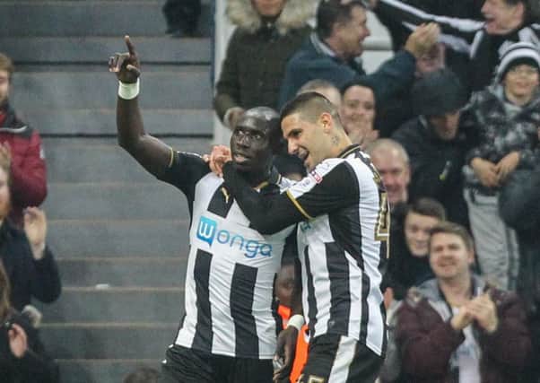 Newcastle United's Mohamed Diame celebrates scoring his side's second goal against PNE with teammate Aleksandar Mitrovic