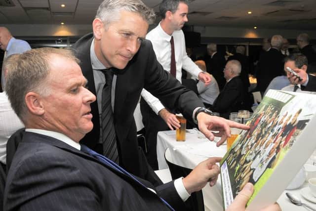 Neil McDonald and Graeme Atkinson with a picture from the 1996 promotion party