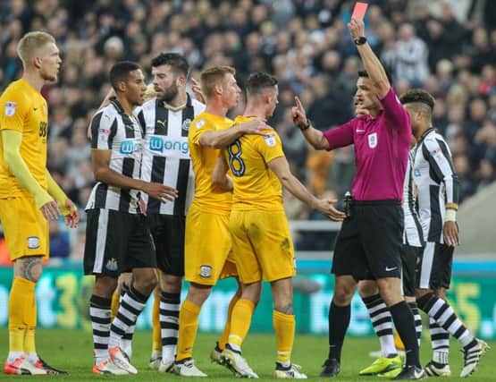 Referee Andrew Madley shows Preston North End's Alan Browne the red card after a challenge in the air with Newcastle United's Jack Colback
