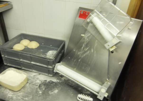 Unguarded pizza dough roller at Pizza City, Friargate