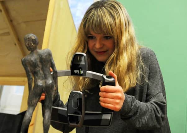 Georgia Henshall tries out a 3D scanner at the museum
