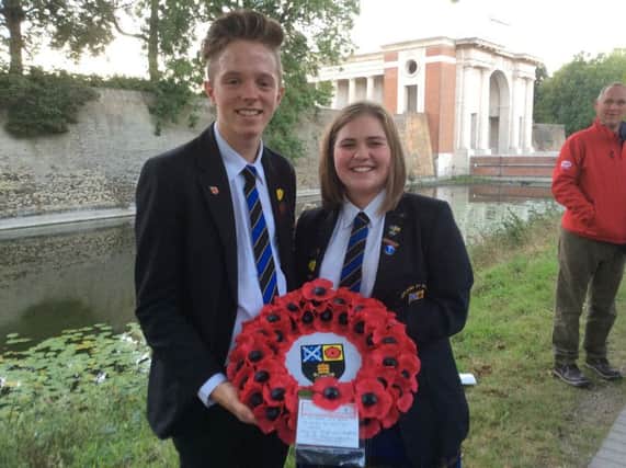 Eve and James lay a tribute for their school at the war graves, which they laid at the Menin Gate