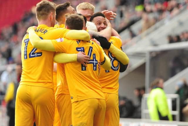 Callum Robinson is congratulated by his team-mates after scoring PNE's second goal