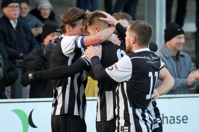 Marcus Carver is mobbed by his team-mates after hitting the winner for Chorley against Nuneaton
