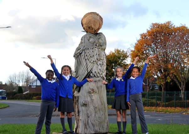 Photo Neil Cross
Fiyin Oladejo, Amber Cragg, Ella Gore and Tayla Finley with the new owl sculpture, at the roundabout near Longsands Primary School, after the first one was knocked over by a driver