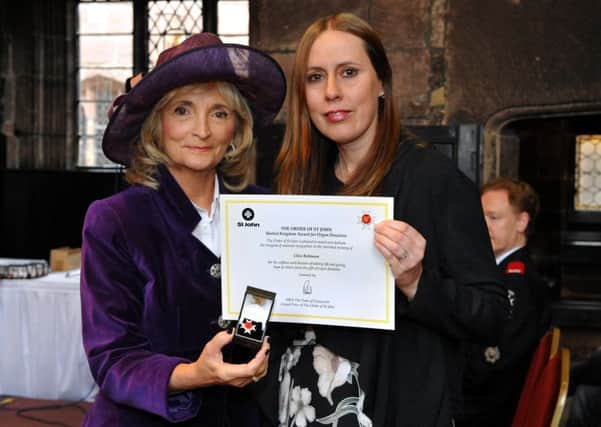 Vice lord lieutenant Edith Conn (left) presented Kate Overend with the Order of St John award on behalf of her father, Clive Robinson