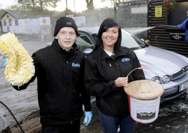 Staff at Pristine Car Wash in Penwortham are asking for donations for a local family whose home was destroyed by a fire.  Pictured are Ryan Ashbee and Louise Pratt.