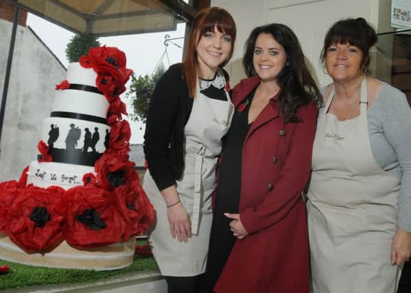 Lucy Gillhespy, Lisa Marie Ousby and Mags Procter, at Lisa Marie Cakes, Longridge, with the Remembrance tribute window display.
