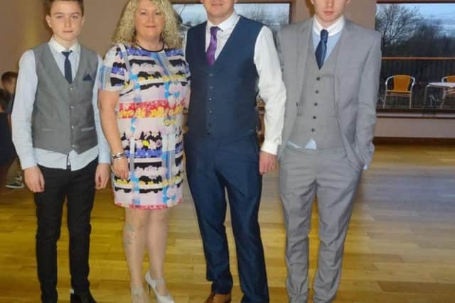 Luke Moss (left) with his parents Yvonne and Jeremy, and older brother Lewis
