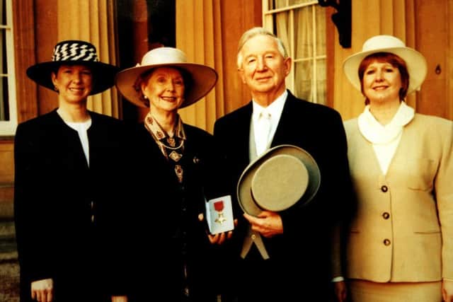 Coun Ken Palmer receives his OBE with wife Cecilia and daughters Angela (far left) and Helen.