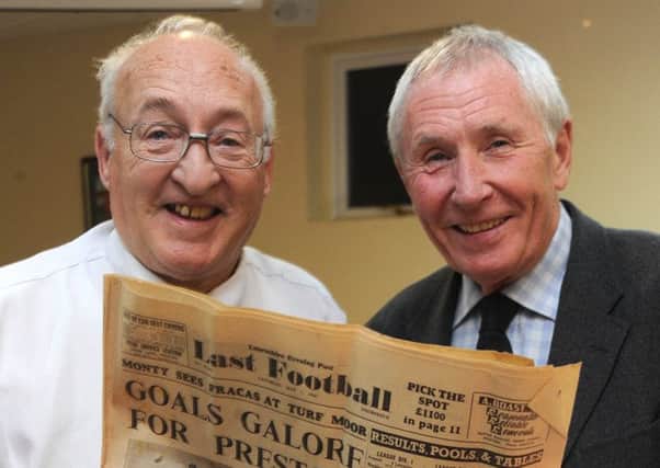 Wilf Riley (left) looks at the  report of Preston's 9-0 thrashing of Cardiff with  Brian Greenhalgh, who scored two goals for PNE in that match