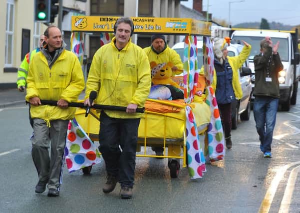bedding in: Graham Liver pulls a bed through Chorley on his way from Pudsey to Bare