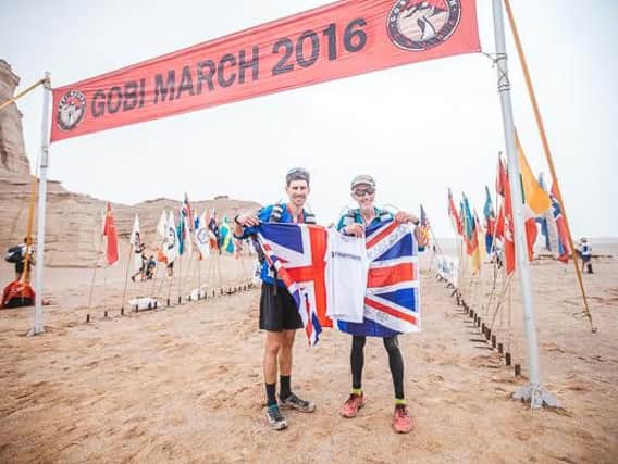Mike Thompson and his son Dean at the finish line in the Gobi Desert