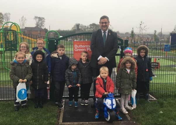 Councillor Adrian Lowe with children at the official opening of the new Buttermere Green toddler play area