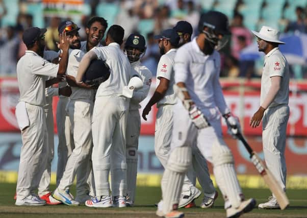 The Indian players celebrate after the fall of Moeen Ali