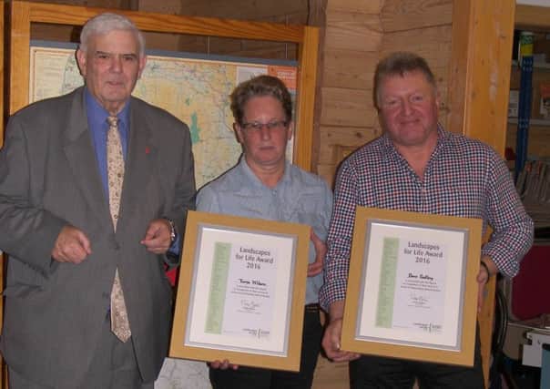 Tarja Wilson and Dave Padley received their Landscapes For Life awards from County Coun Albert Atkinson