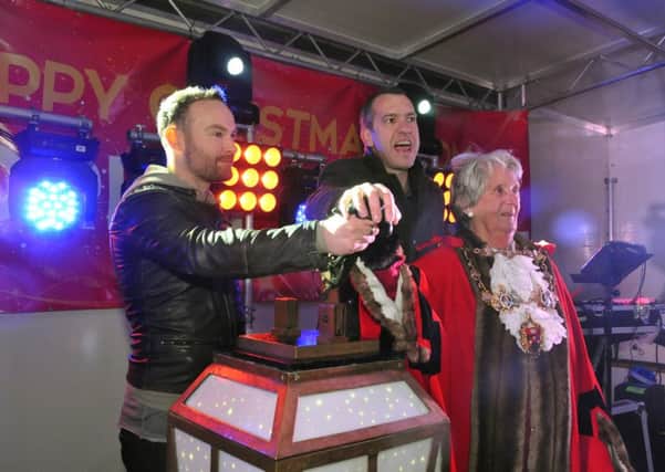 Kevin Simm, Chorley Council leader Alistair Bradley and Mayor, Councillor Doreen Dickinson flick the switch in Chorley last night