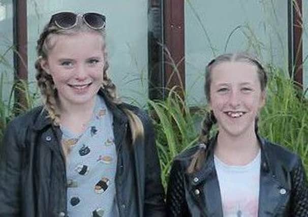 Megan Whalley and Niamh McMoran-Elliot who fundraised almost Â£1,000 for Adlington Library