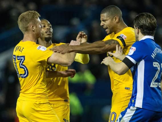 Eoin Doyle and Jermaine Beckford clash, with Daniel Johnson trying to pull them apart