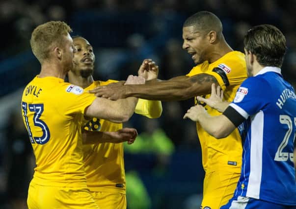 Eoin Doyle and Jermaine Beckford clash, with Daniel Johnson attempting to be the peacemaker