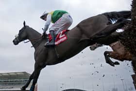 2014 Grand National winner Many Clouds ridden by Leighton Aspell clears the last fence on the way to winning the Betfred Chase at Aintree