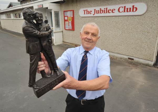 Photo Neil Cross: Jubilee Working Mens Club president Dave Miller with the plaque to mark the beginning of the Morecambe and Wise heritage trail, on the stage where Eric Morecambe had his first paid performance as a child. The Heritage Trail was launched at the club earlier this year.