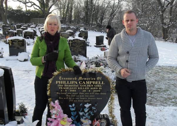 Phillipa Campbell's muim and brother at her grave. Phillipa was killed at the age of 19 in a crash after her sports car was driven by a friend who had been drinking and was speeding.