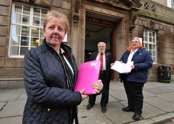 Patricia Varty giving the petition to deputy leader  of Preston Council John Swindells and Coun Jonathan Saksena