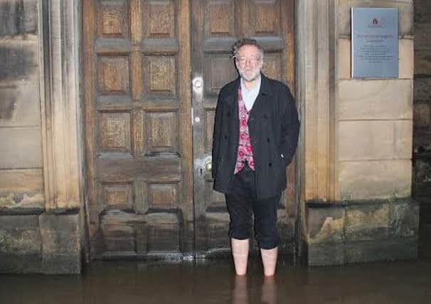 Bruce Crowther outside St John's Church on the Sunday morning after the floods struck. Photo by Richard Davis.