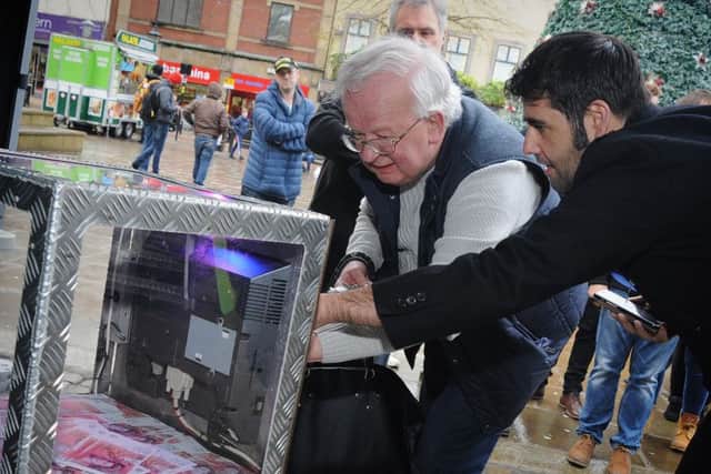 Preston shoppers had the chance of a bumper Christmas by attempting to crack the code of the 'City Safe' containing Â£10,000.
City Centre BID Manager Mark Whittle helps to key in a code.  PIC BY ROB LOCK
10-12-2016