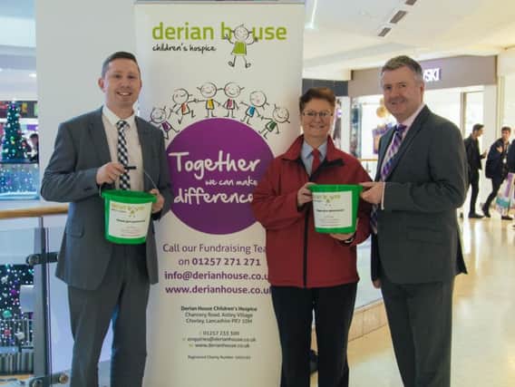 Derian House community fund-raiser John Rollo with Alison Goodreid and Andrew Stringer of St George's Centre, Preston