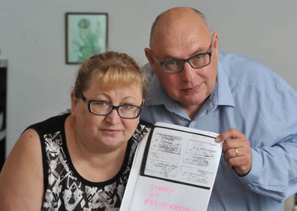 Sad tale: Iryna and Malcolm Bennett with their documents