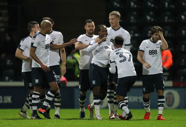 Daniel Johnson is mobbed by his team-mates after opening the scoring