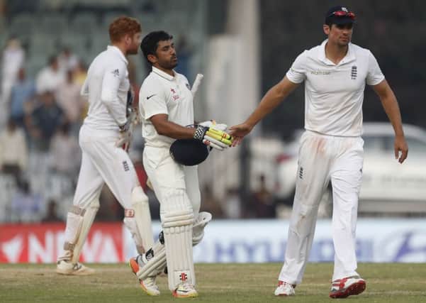 England's captain Alastair Cook, right, shakes hand with India's Karun Nair after he reached his 300.