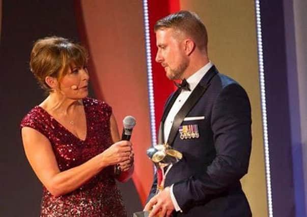 Stuart Robinson with his 'Millie' award for overcoming adversity with TV personality Lorraine Kelly. Picture:  BFBS and Forces TV.