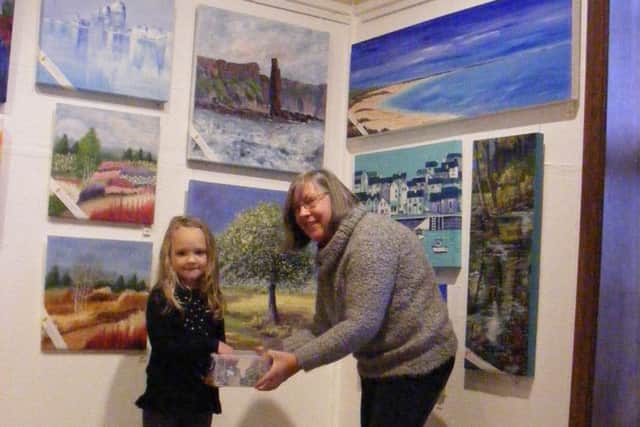 L-R: Natalia Walsh makes the draw. She is pictured with Brenda Smith of Lodge Artists in Chorley