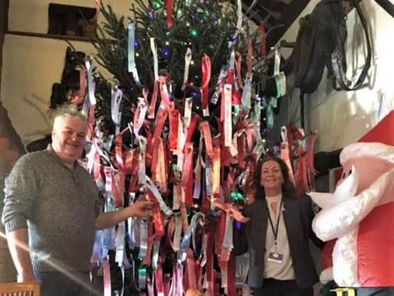 Gary Kirby and Helen Hartin by the Christmas tree