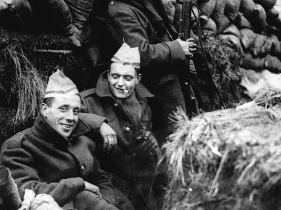 First World War  soldiers in a trench on the Western Front in France wearing paper hats from Christmas crackers