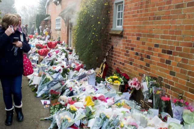 Tributes continue to be left outside George Michael's house in Goring-on-Thames, Oxfordshire, following the singer's death.